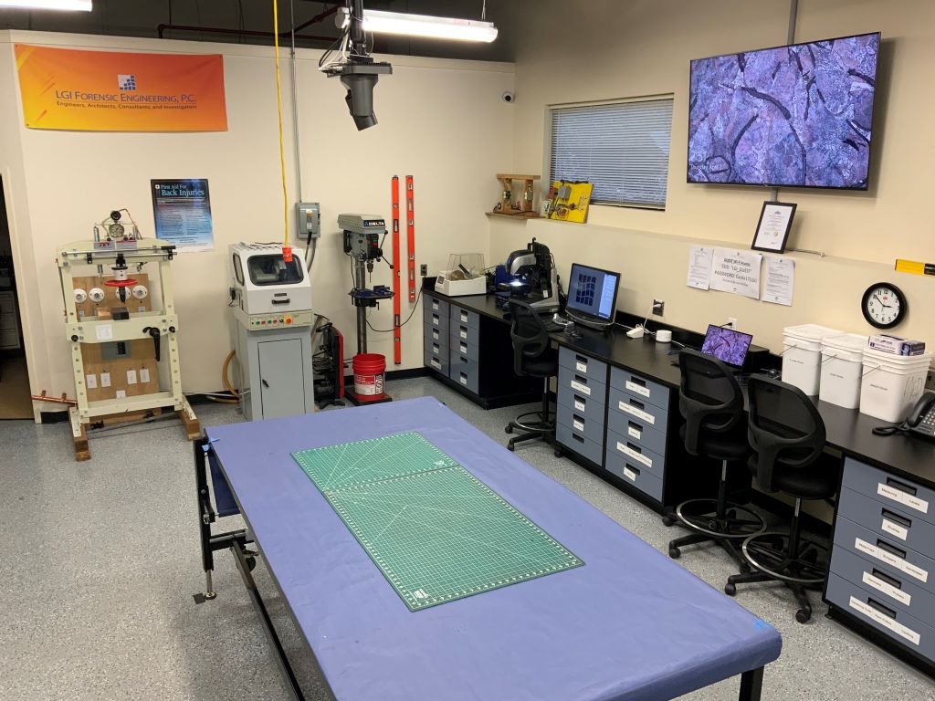 LGI's on-site Virtual Examination setup showing cameras, the examination table, the microscope, and multiple monitors.